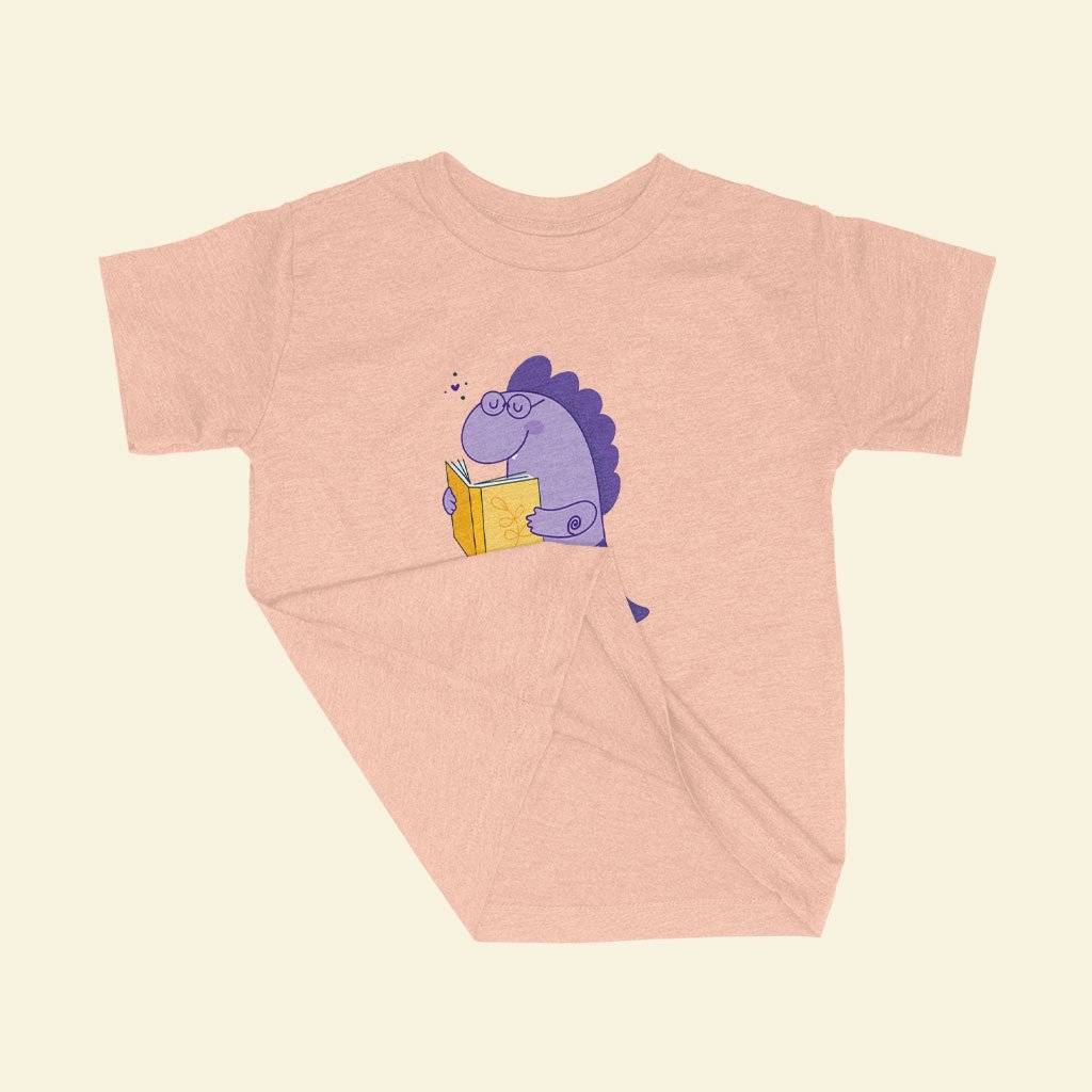 85164-03b332.jpeg Toddler Dinosaur Reading Triblend T-Shirt Kids & Baby Toddler Clothing Color : Ice Blue Triblend|Olive Triblend|Peach Triblend